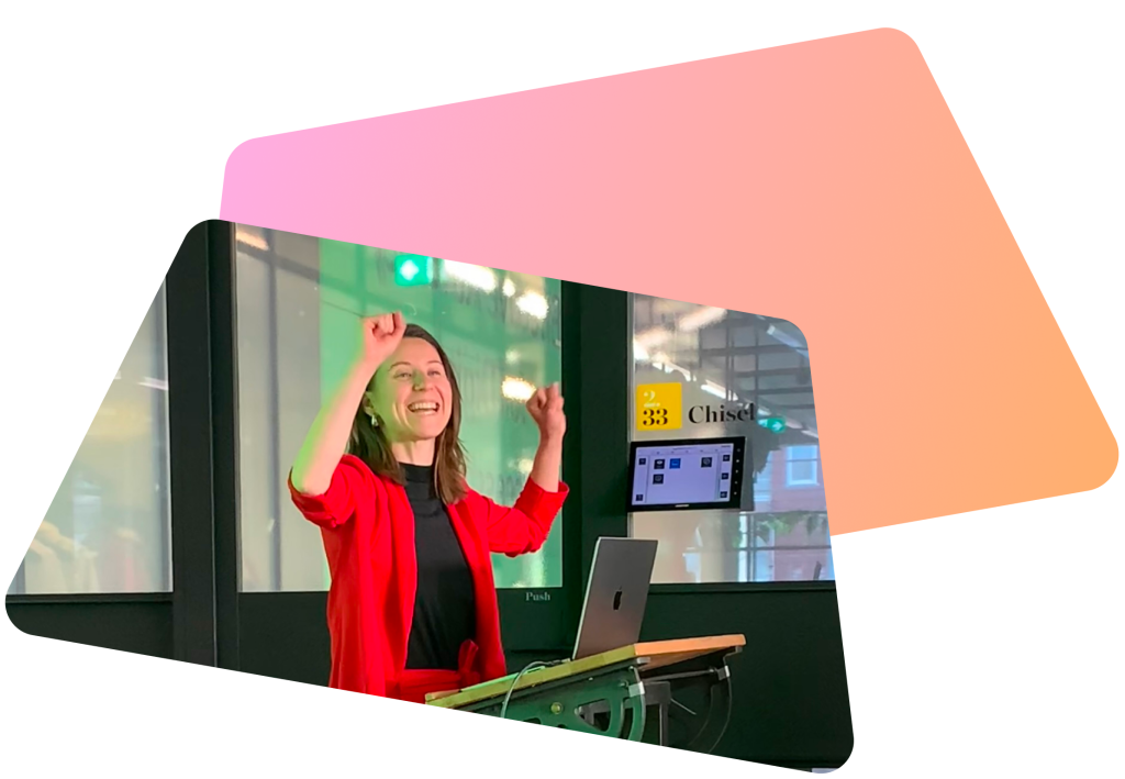 A picture of Carmen Burghardt in a celebratory pose during a presentation.